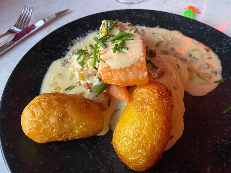 Poached fillet of salmon with cheddar and leek sauce, creamed and roast potatoes with vegetables.Dalmeny park 